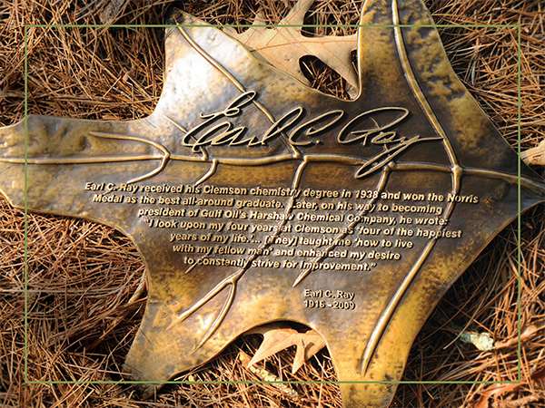 Bronze oak leaf in honor of Earl C. Ray.